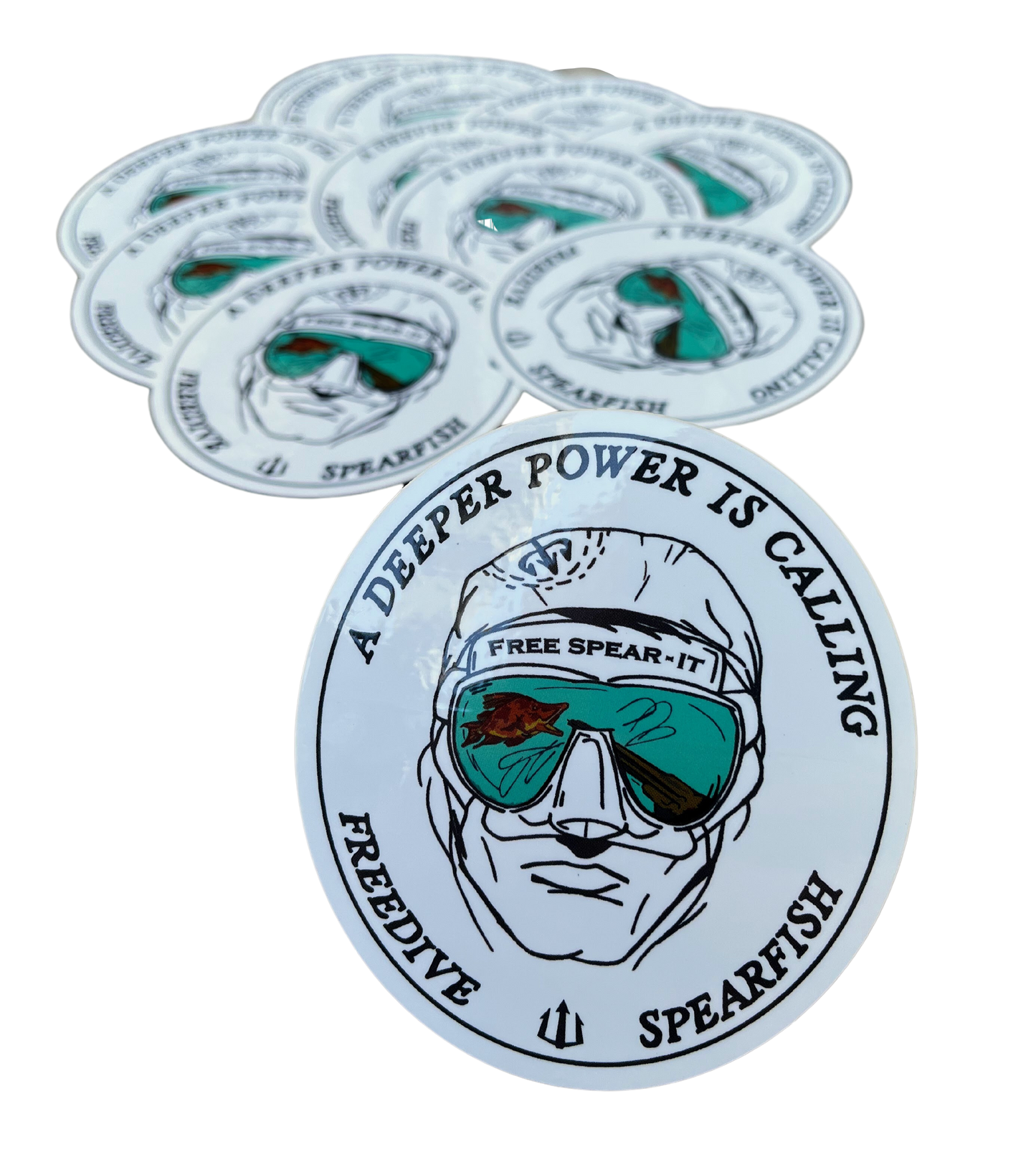 A stack of Free Spear-It Deep Reflections 3.5-inch oval stickers featuring a freediver's face with mirrored mask reflecting a speargun and a hogfish, along with the phrase "A Deeper Power Is Calling" and FreeSpear-It.com