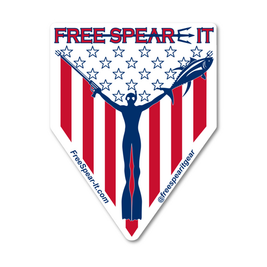 Free Spear-It "Spear-It of Freedom" 4-inch sticker featuring a bold red, white, and blue design with a freediver holding a speargun and fish against an American flag backdrop.  The website FreeSpear-It.com and social media handle @freespearitgear are printed along the bottom border of the sticker.