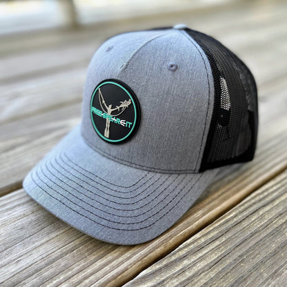 Close-up of the Free Spear-It PVC Logo Snapback Hat in heather grey and black, featuring a durable PVC rubber patch with a freediver and speargun design. This Richardson trucker hat blends comfort and performance, perfect for spearfishing, boating, and everyday wear.